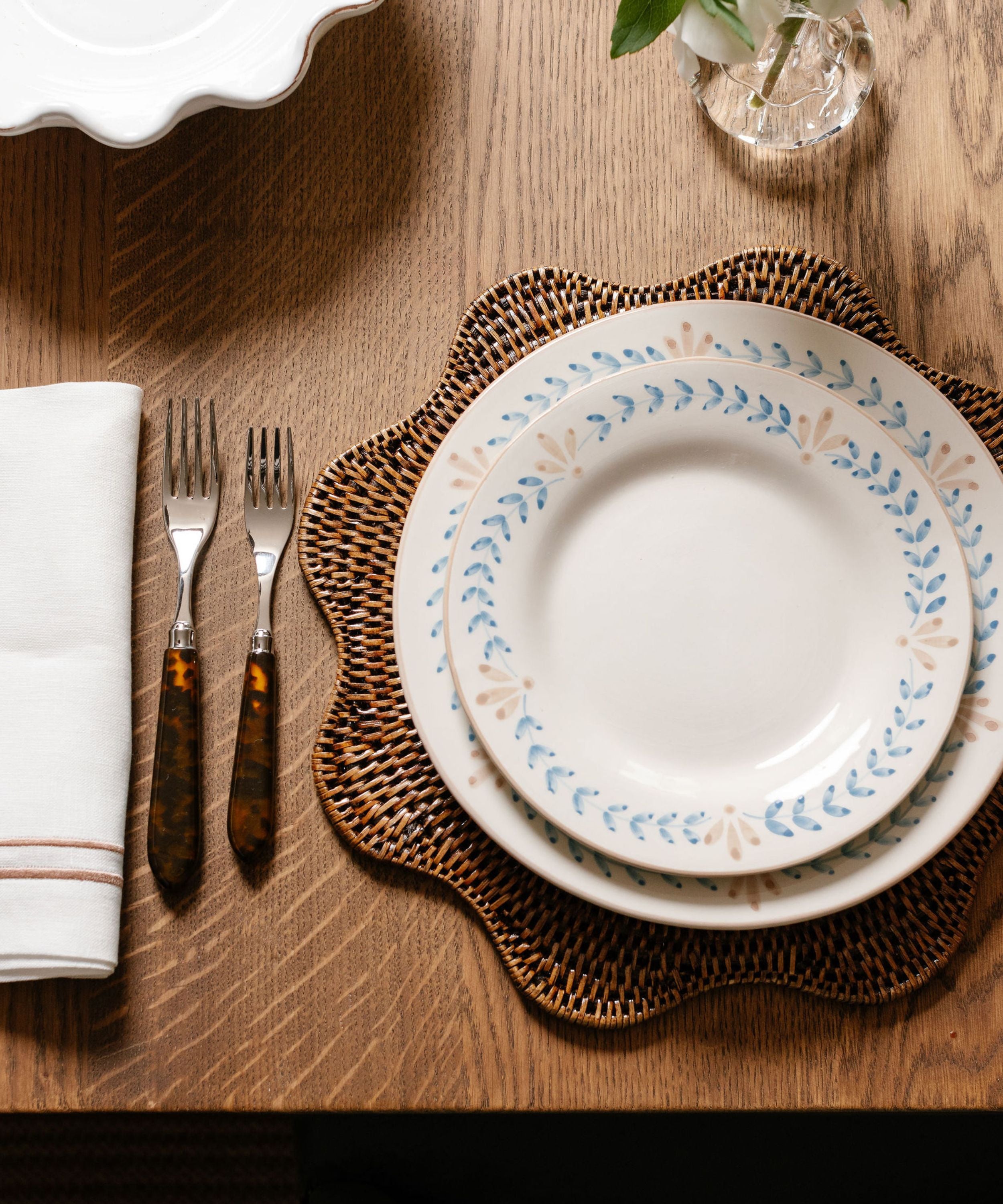 Rebecca Udall Scalloped Wavy Hand Woven Rattan Placemat, Dark Brown with the Elouise Crockery, Blue