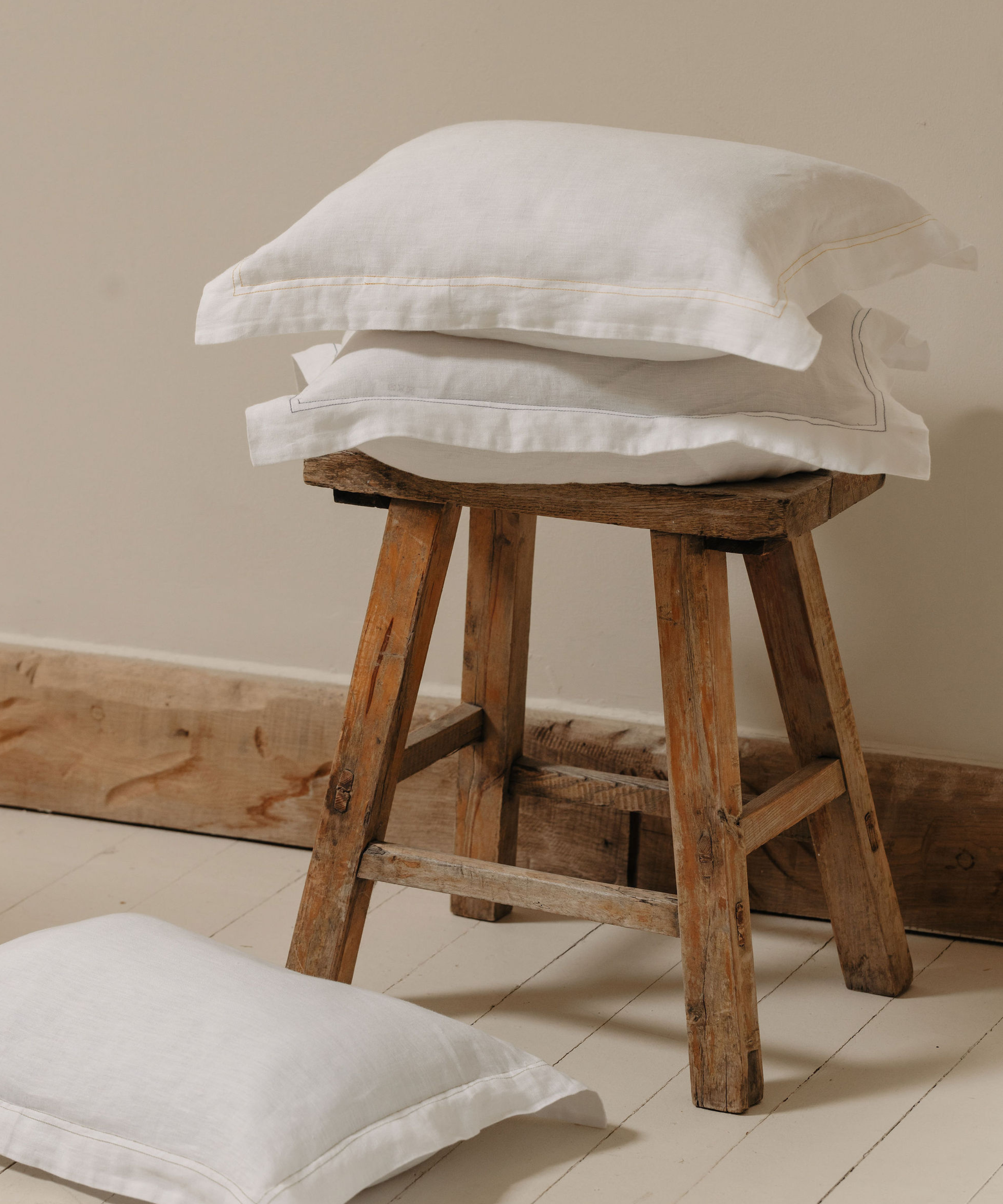 Rebecca Udall, Darcy Linen Boudoir Pillowcases on a wooden stool