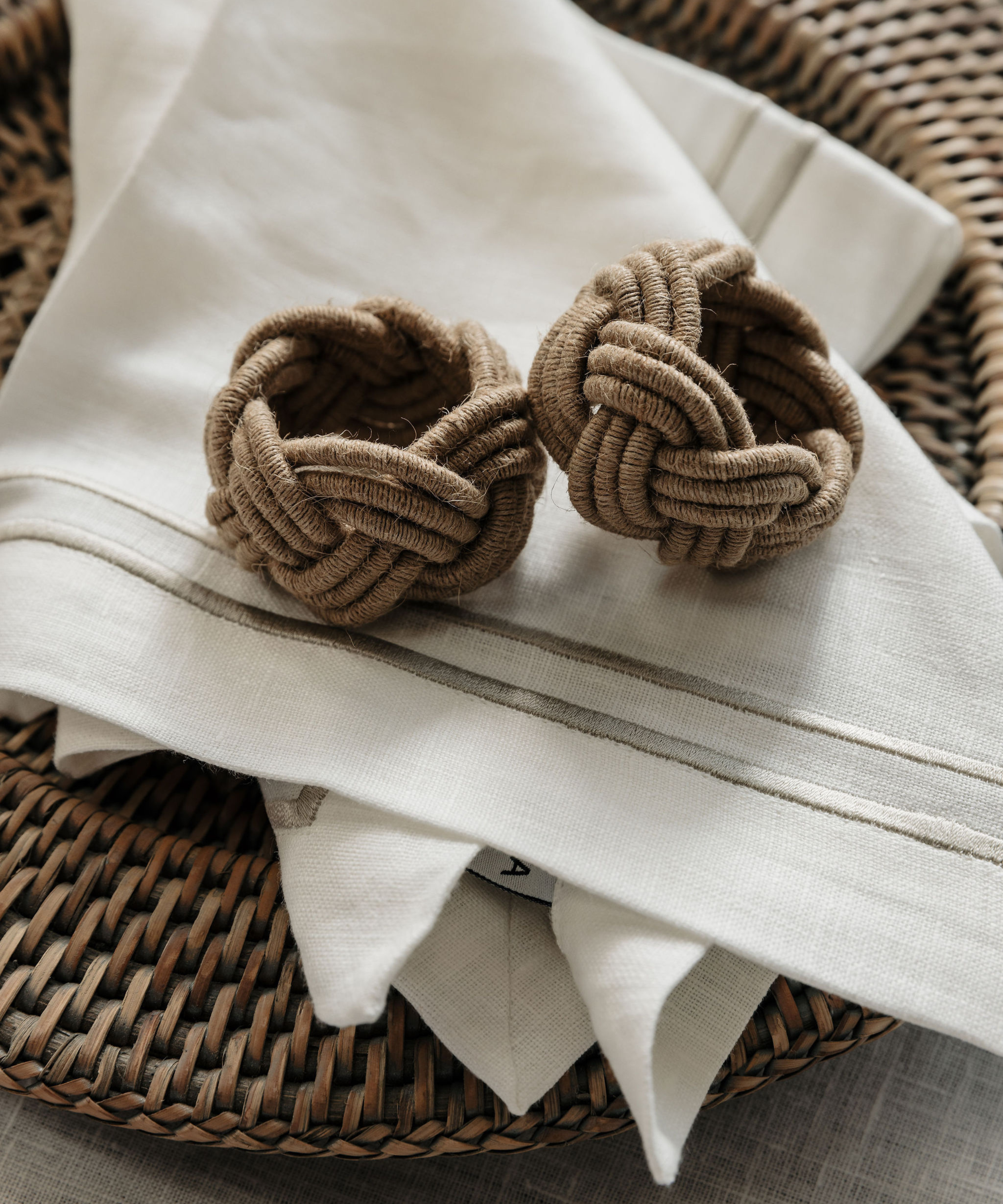 Rebecca Udall Rattan Charger, Taupe with Braided Napkin Rings, Lifestyle