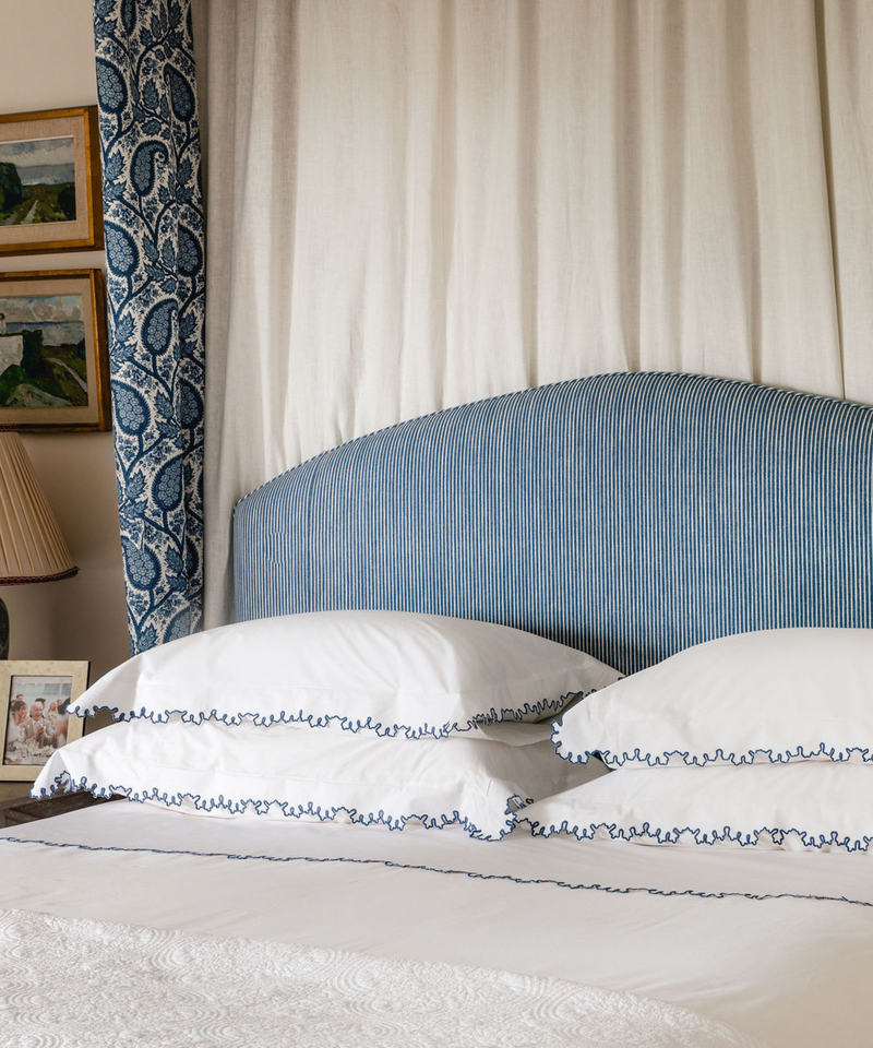 Rebecca Udall, Thea Scalloped Bed Linen, White with Denim Blue Edge Trim  on Bed