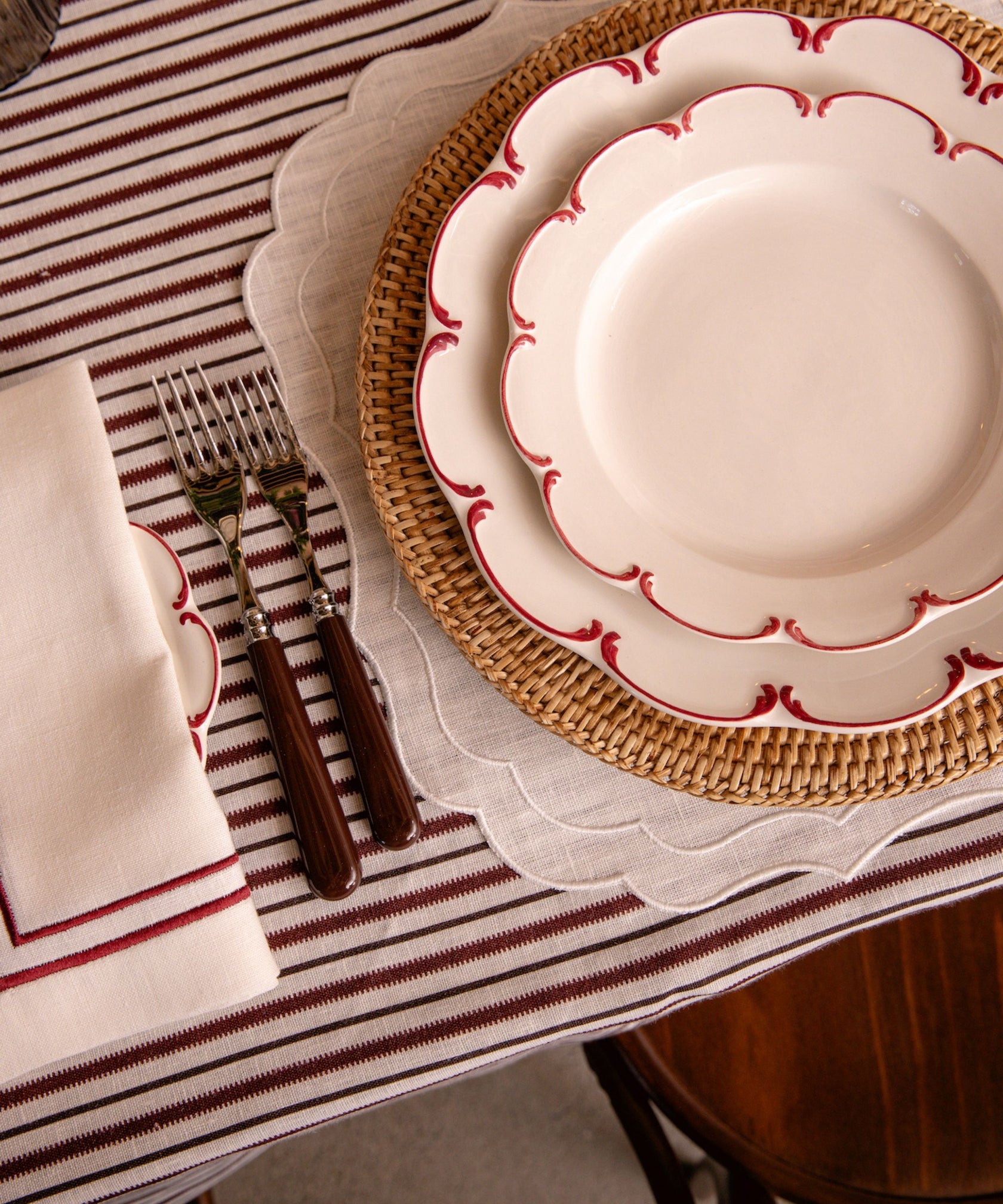 Olivia Scalloped Crockery, Raspberry Filet, with Rattan Charger