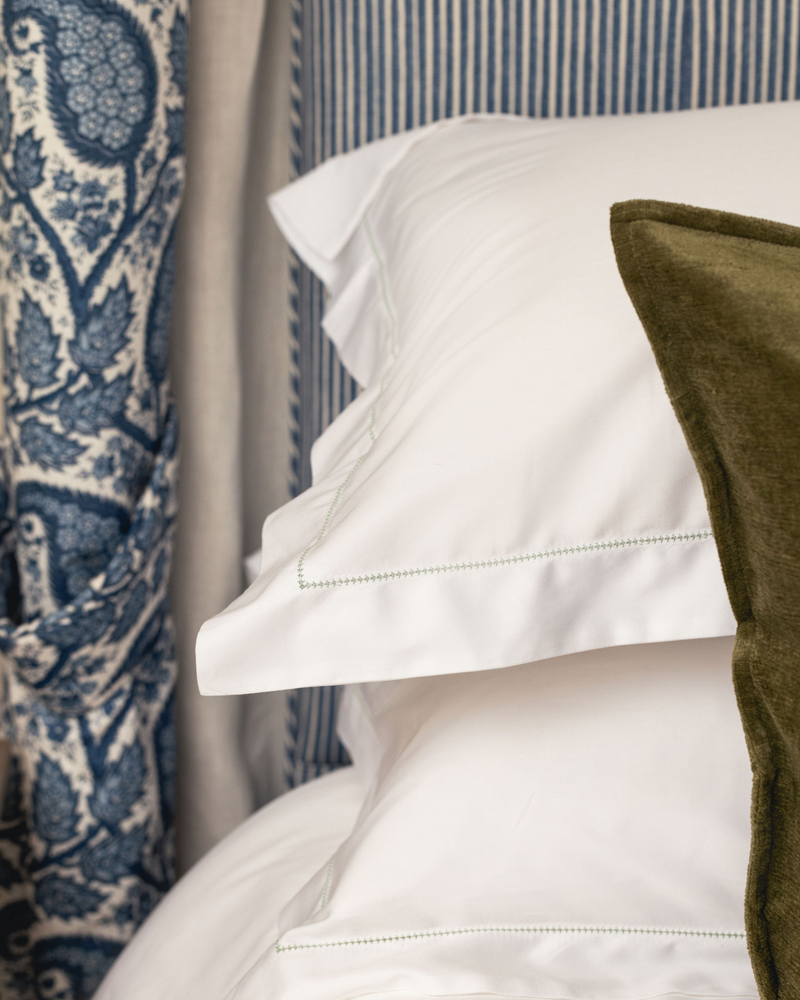 Rebecca Udall Porto Hemstitch Bed Linen, White with Green Stitching Pillows Close Up Lifestyle