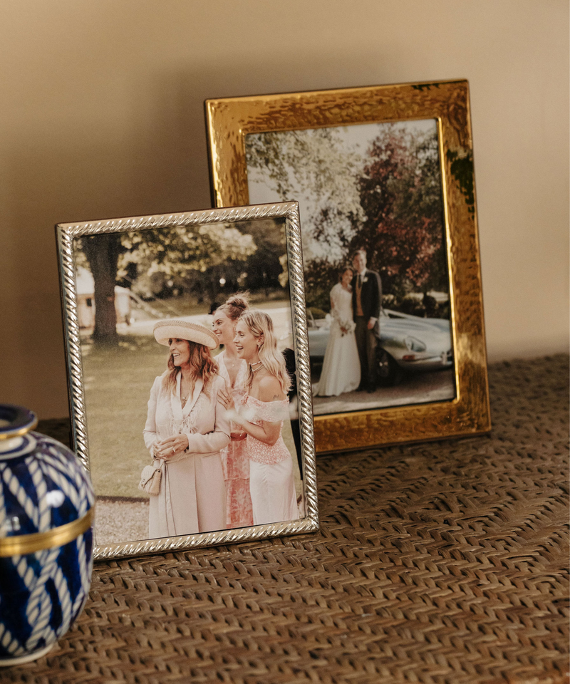 Rebecca Udall Gold Plated Hammered Photo Frame, Displayed on Shelf Next to Sterling Silver Twist Photo Frame. 