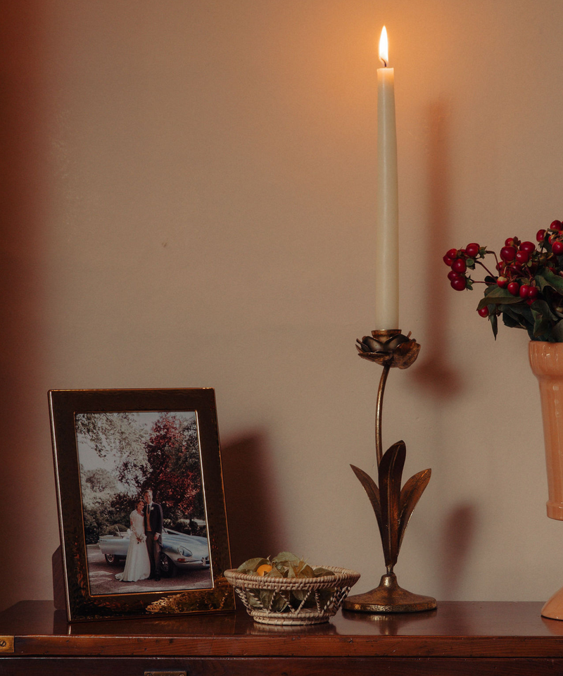 Rebecca Udall Gold Plated Hammered Photo Frame, Displayed Next to Brass Hellebore Candlestick.