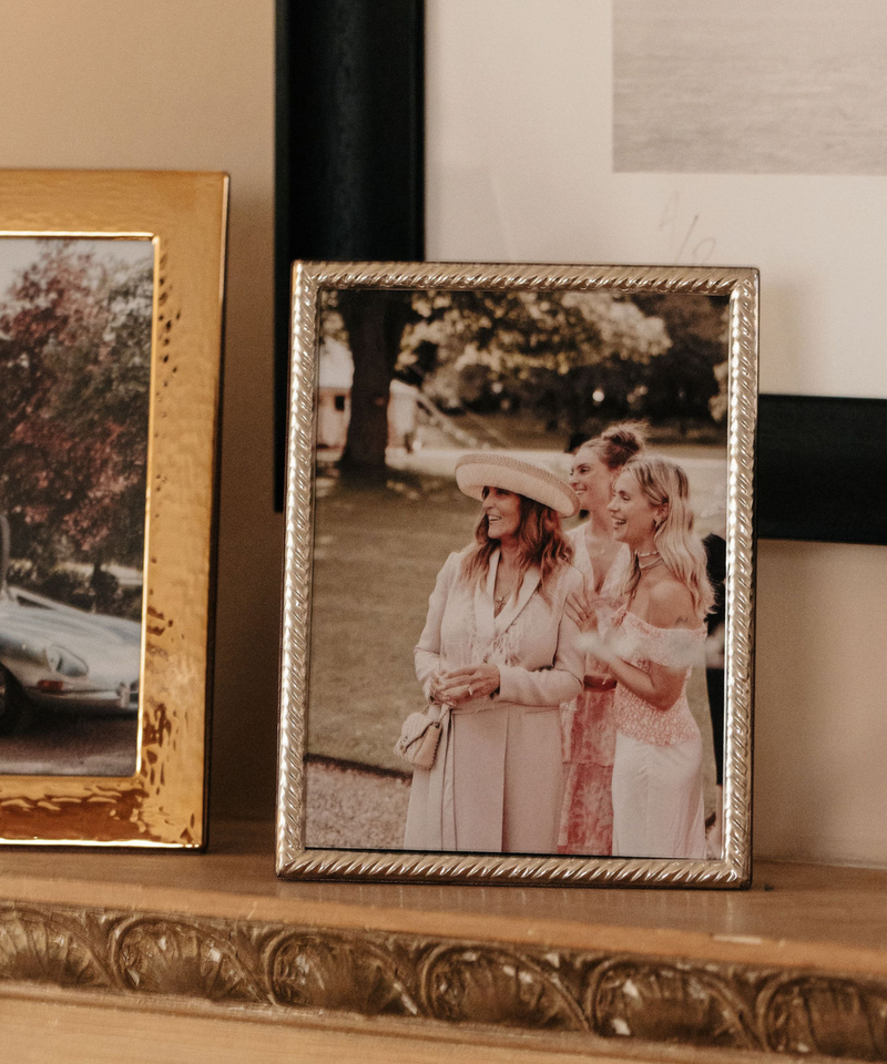 Rebecca Udall Sterling Silver Twist Photo Frame displayed on Shelf Next to Gold Plated Hammered Photo Frame.