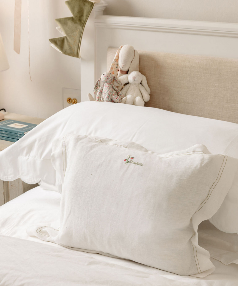 Rebecca Udall, Lottie Mayland x Rebecca Udall Darcy Boudoir Linen Pillowcases, dsplayed on a bed.